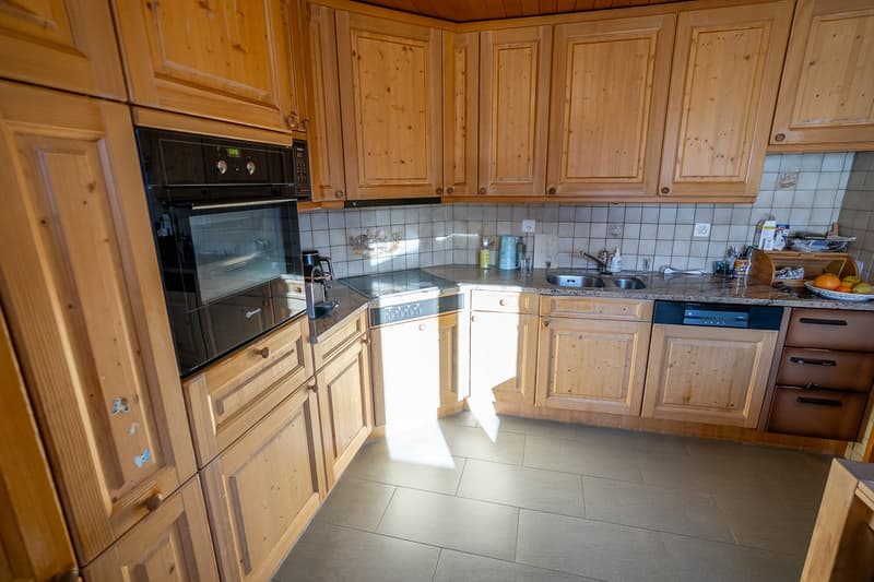 Wooden cabinets, tiled floor, modern appliances, countertop, modern kitchen
