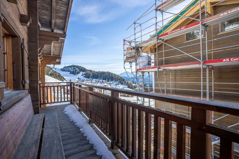 wooden balcony, wooden railings, snowy ground, wooden bench