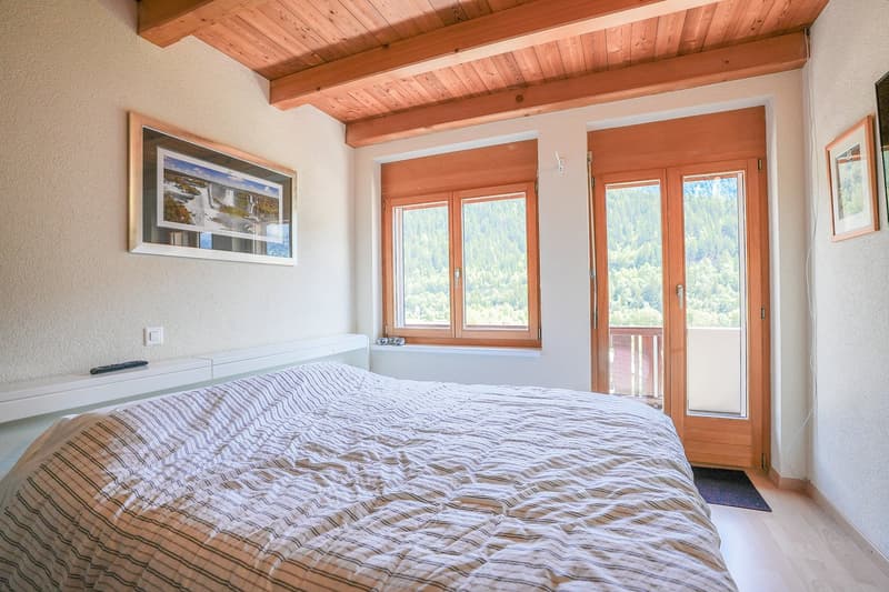 double bed, wooden ceiling, two picture frames, double window with balcony, hardwood floor