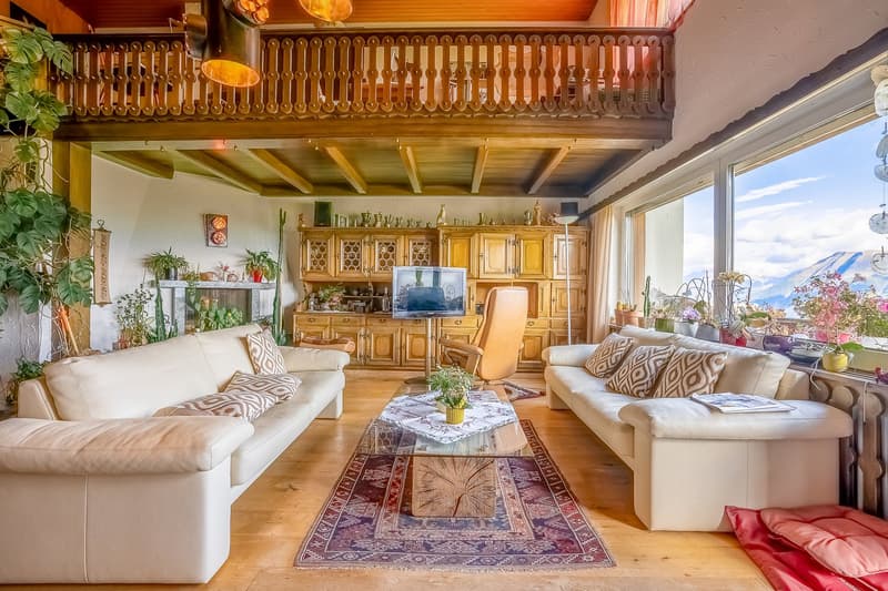 wooden floor, wooden cabinet, glass coffee table, sofa, armchair, TV, floor lamp, balcony, radiator, radiator covers, large windows, plants, carpet