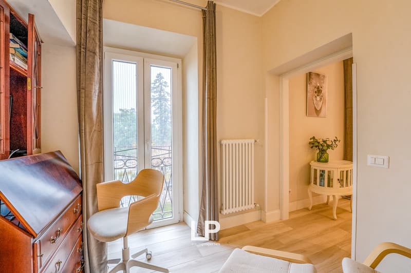 wooden furniture, chair, wooden cabinet, large window with balcony, radiator