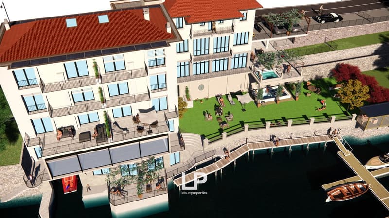 Two story building, tiled roof, balconies, swimming pool, waterfront location