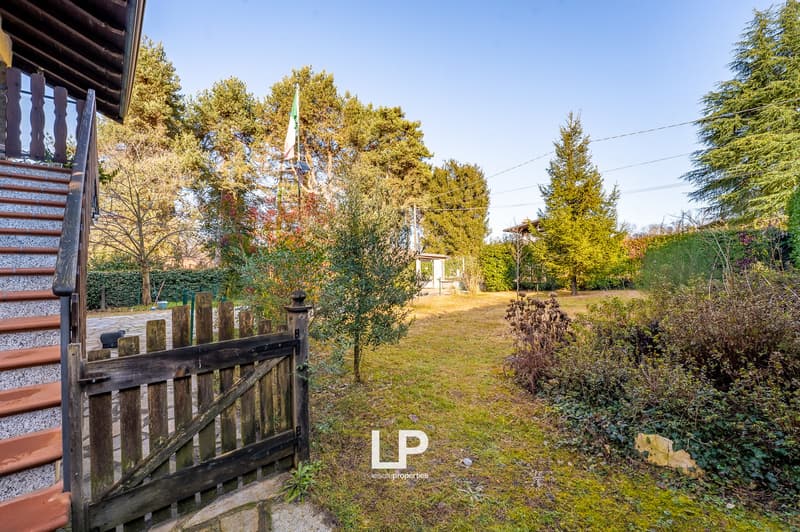 steep stairs leading to the front door, garden, gate, flag pole