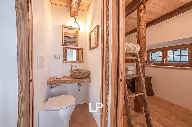 white toilet, wooden sink, wooden ladder, wooden floors