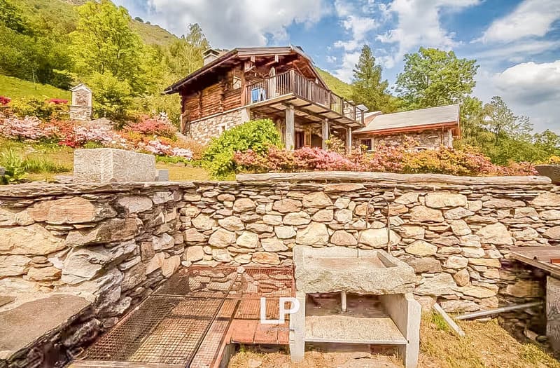 Wooden chalet, large balcony, stone walls, lush garden, fireplace