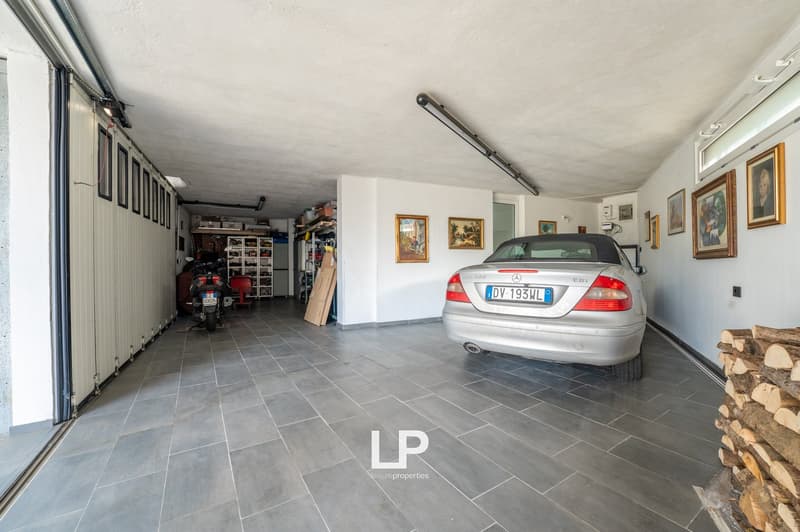large car, car parked, motorcycle, shelves, paintings, wooden logs