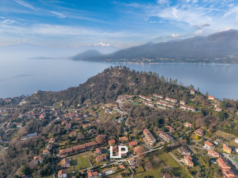 Aerial view of a town, many houses, large lake, mountains