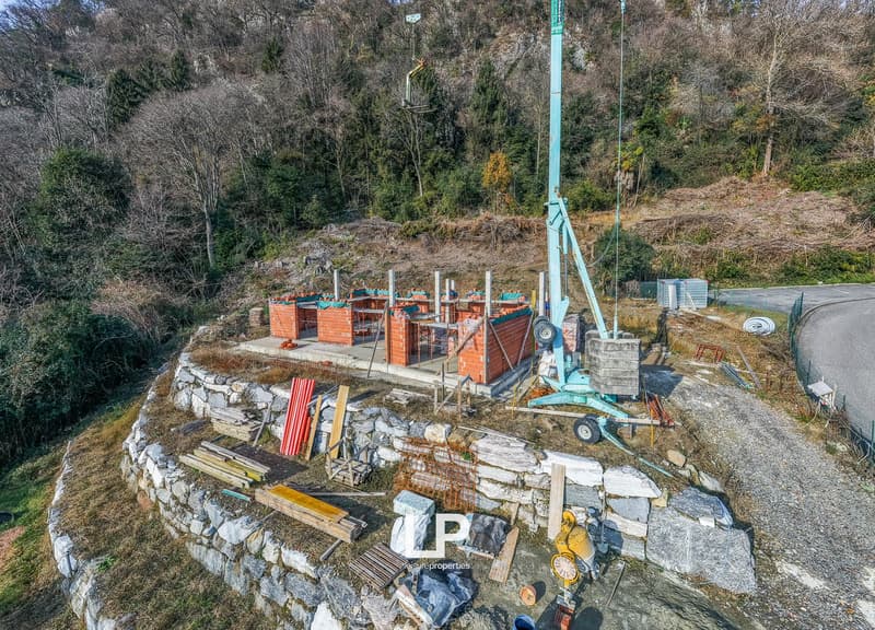 Under construction, brick structure, crane, stone walls, various construction materials