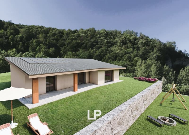 modern, single-family house, raised ground floor, large windows, solar panels, landscaped garden with artificial turf