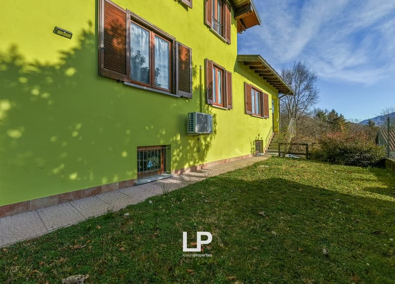 yellow exterior, wooden shutters, multiple windows, covered entrance, front yard, grassy lawn