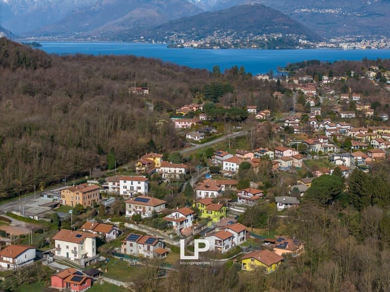 village with many houses, mountains, lake, greenery