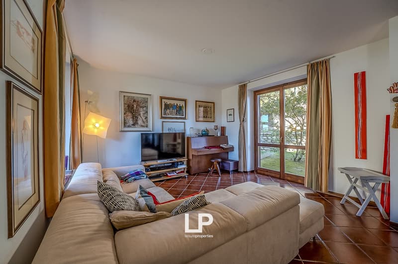 ample L-shaped sofa, TV, piano, floor-to-ceiling windows, tiled floor