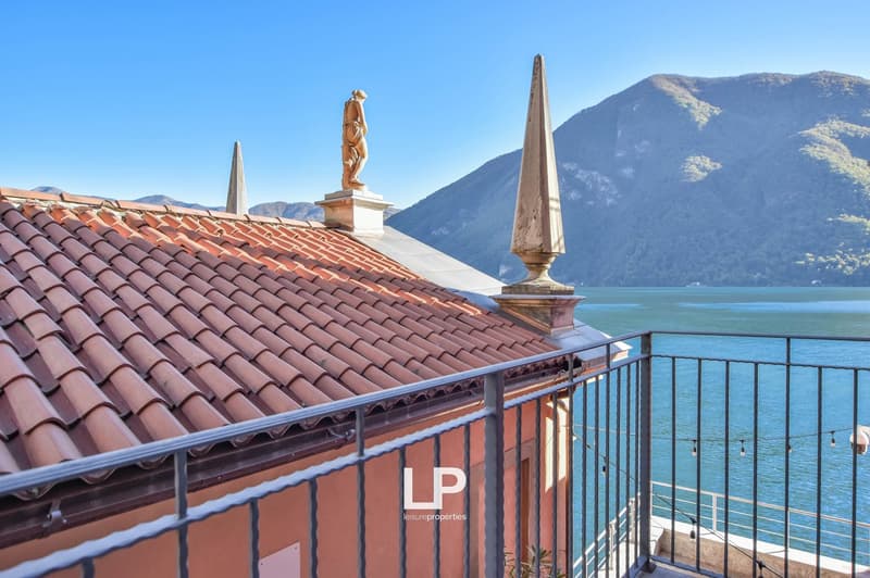 terracotta roof, metal railing, balcony with lake view, statue, mountains
