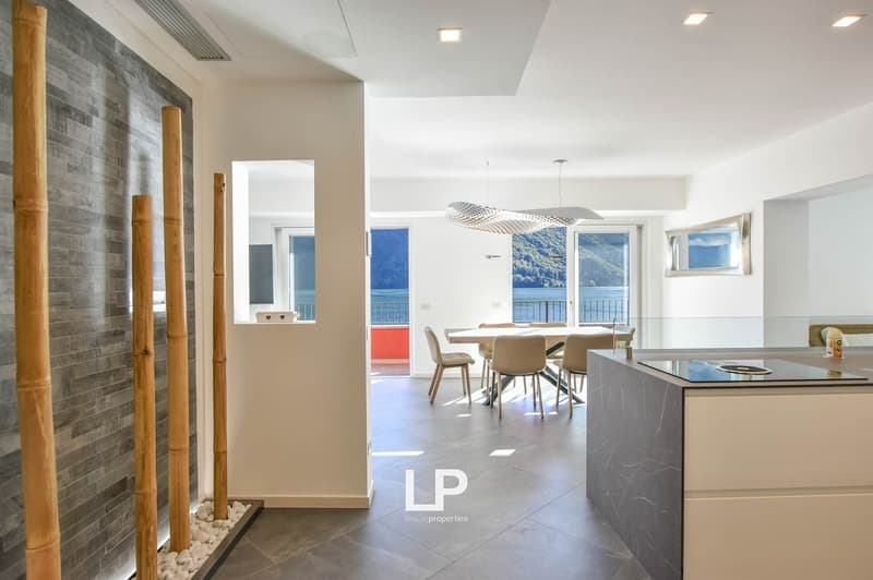 Modern interior with open plan living and dining area, modern kitchen, gray and white color scheme, large windows, dining table and chairs, bamboo elements