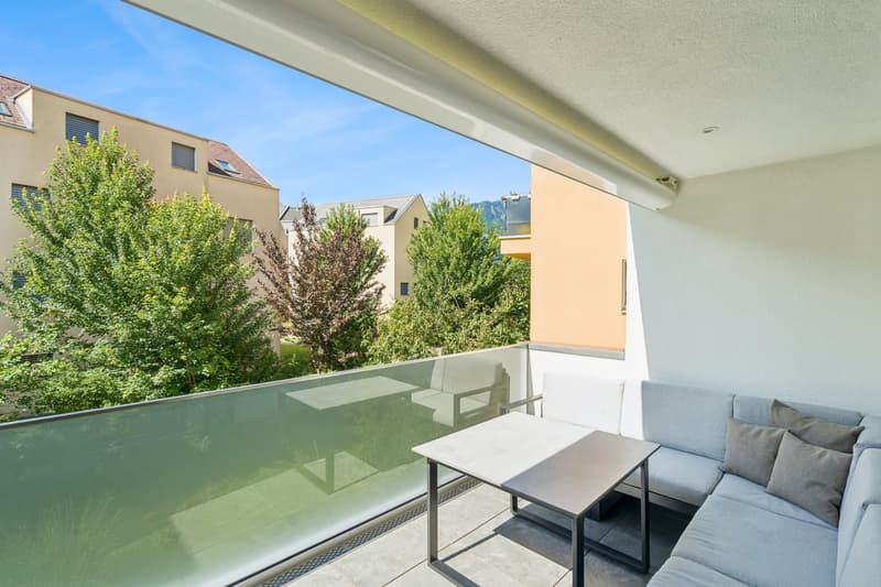 Glass floor balcony, sofa, table, trees, clear sky