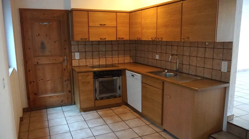 wooden cabinets, tile flooring, sink, dishwasher, oven, counter top, electrical outlet