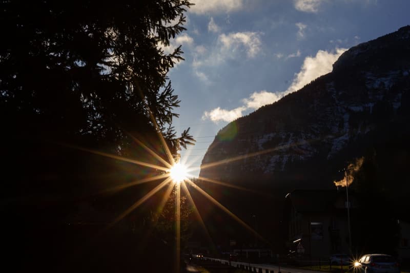 Mountains, trees, sun, sky, road, cars