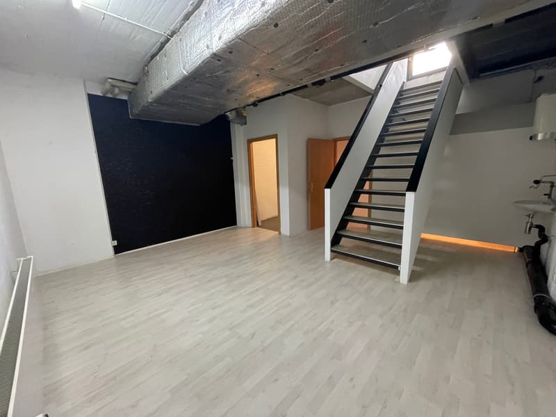 empty room, white walls, wooden floor, stairs, black wall, two doors