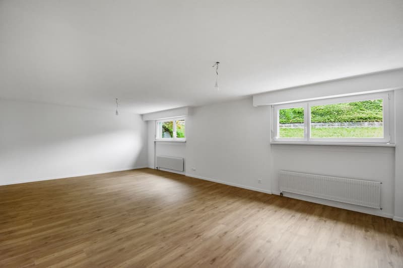 large room, wooden floor, 2 windows, radiators