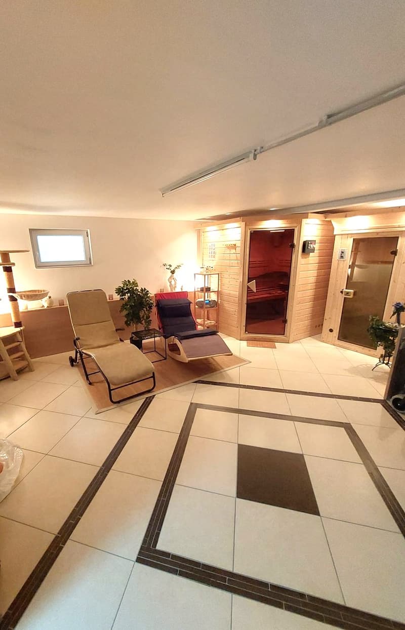 sauna room, tiled floor, lounge chairs, wooden sauna, plants