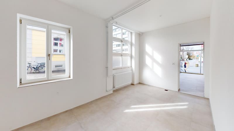 white walls, tiled floor, large windows, modern radiator