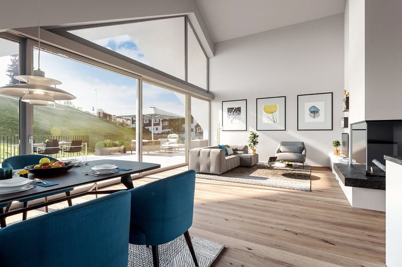 Open living area with sliding doors leading to the balcony. Modern furniture includes a dining table, chairs, and a couch. Large windows provide views of the outdoor landscape.