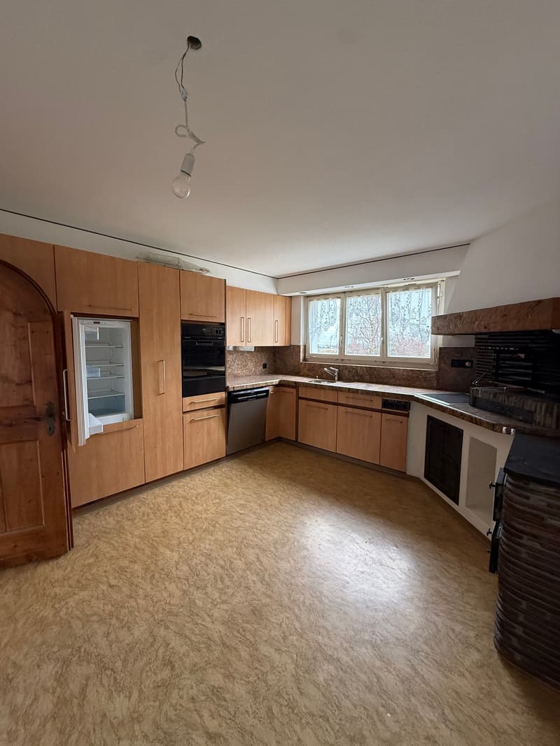 kitchen with wooden cabinets, granite countertops, oven, dishwasher, refrigerator, sink, windows