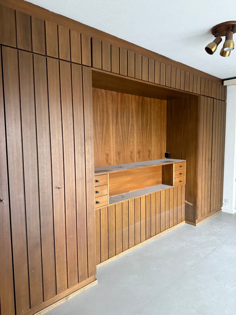 wooden wall panels, built-in wooden cabinet, drawers, power outlet