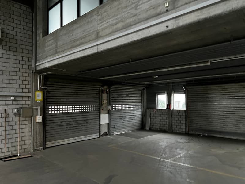 underground parking lot, brick walls, metal shutters, windows, electrical boxes