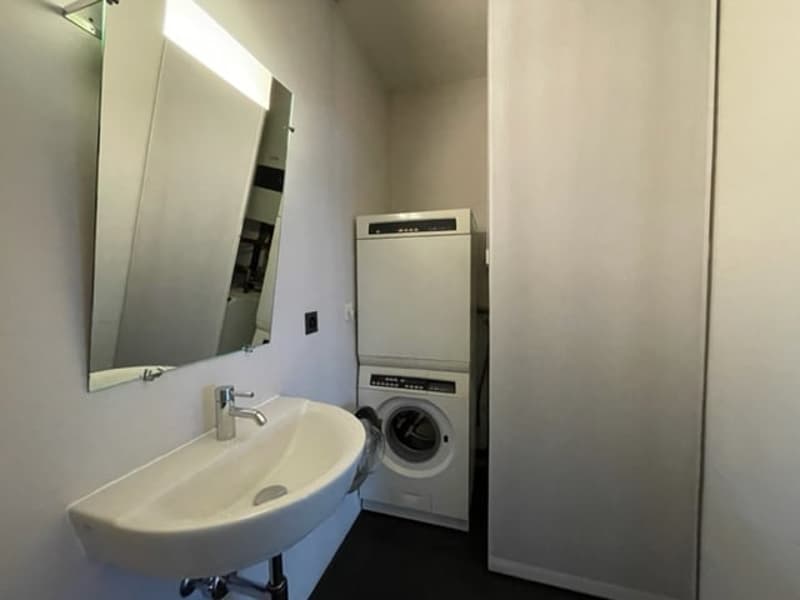 Laundry room with a washing machine, dryer, and a sink