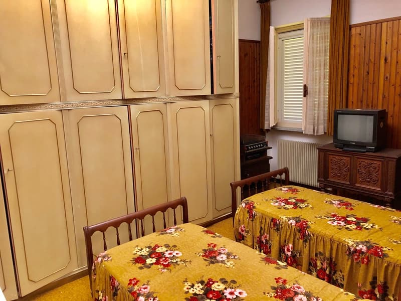 Wooden cabinets, floral patterned tablecloths, wooden furniture, TV stand, curtains