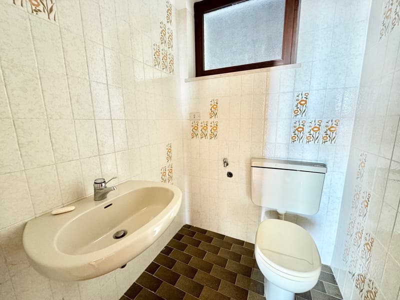 tiled walls, floor, sink, toilet, window