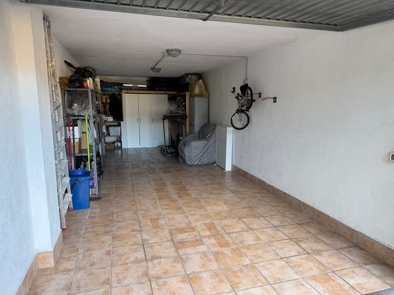 tiled floor, bicycle on the wall, cabinets on the wall, ladder