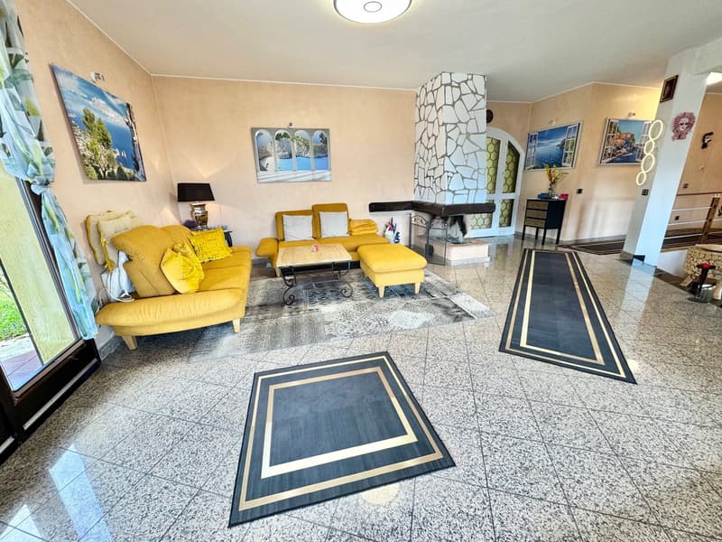 yellow sofas, fireplace, marble flooring, artwork, table, lamp