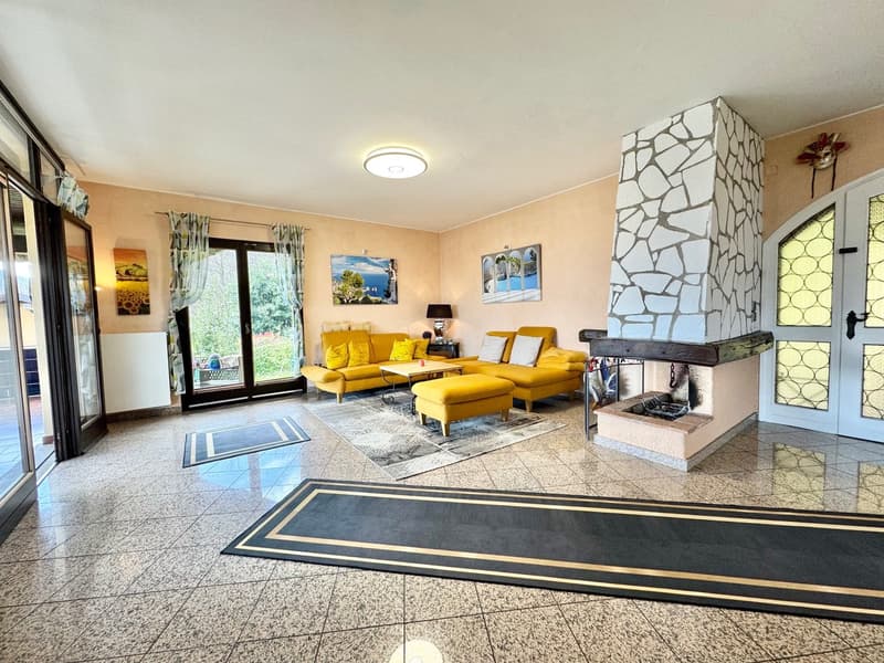 yellow sofas, coffee table, fireplace, glass doors