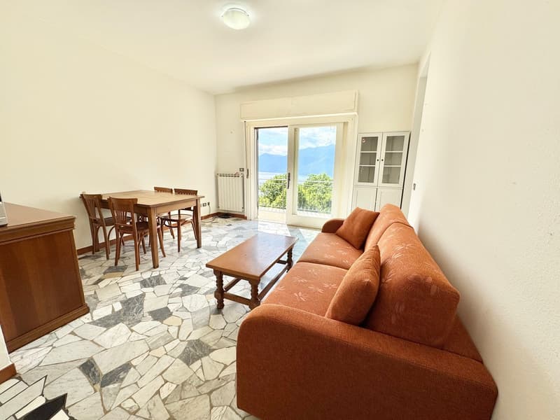 Terrace with mountains view, brown sofa, wooden dining table, wooden coffee table, wooden cabinet