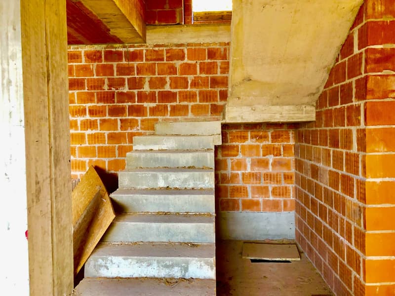 Concrete staircase leading to upper floor