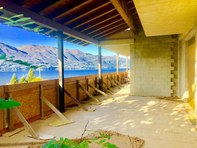 Balcony with wooden beams, fenced with wood, mountain view