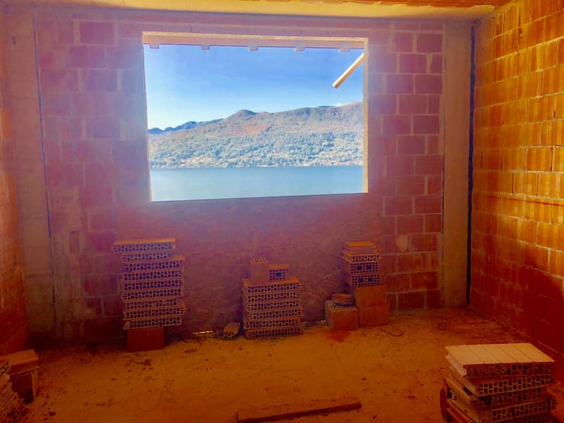 bare room, window with lake view, building material stacks