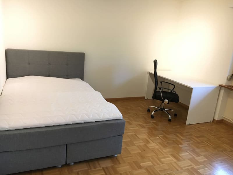 Bedroom with bed, desk, and chair