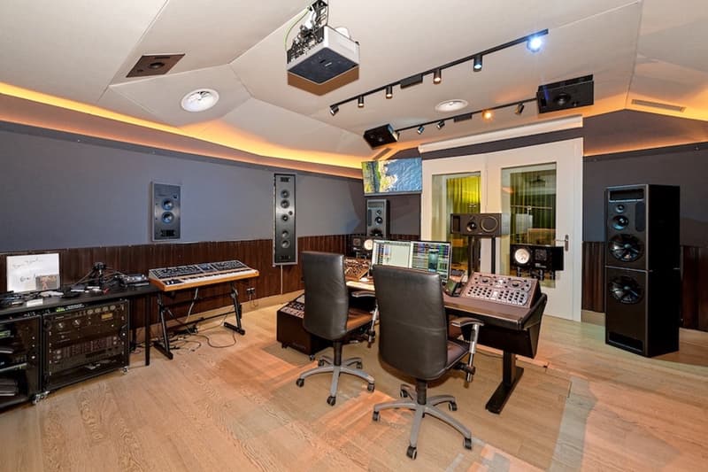large music studio, sound equipments, speakers, keyboard, monitors, desks