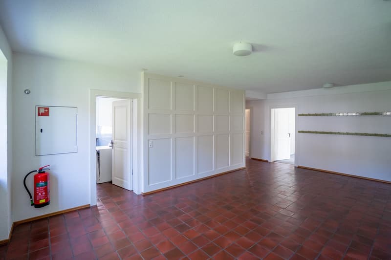 empty room, red tiles, white walls, white ceiling, fire extinguisher, two doors, one with window
