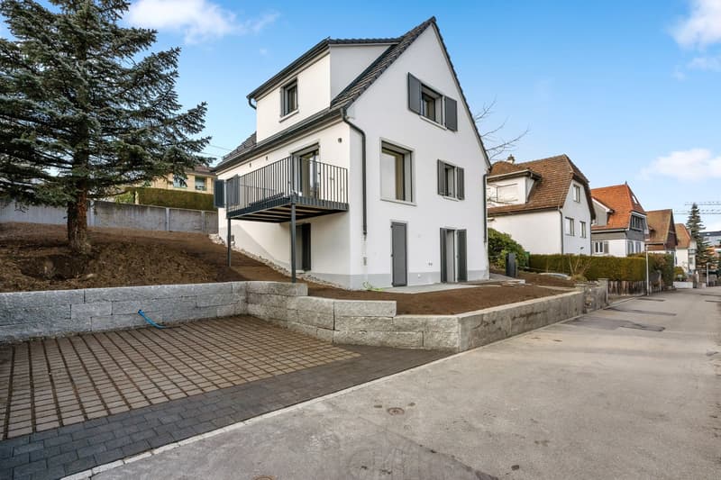 modern white house, 3 stories, balcony, concrete driveway, stone wall, tree