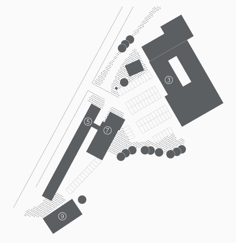 The image appears to be a floor plan or site plan. It shows various rectangular and square shapes representing different structures or buildings, as well as some circular shapes that could be parking spaces or other features. The plan seems to have number