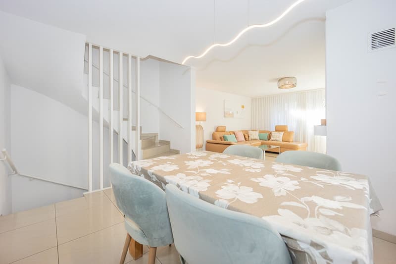 Dining room with table and chairs, open plan with living room