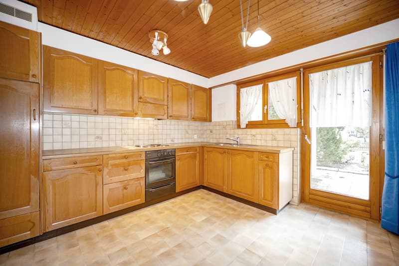 wooden cabinets, tiled backsplash, stainless steel oven, glass door, wooden ceiling