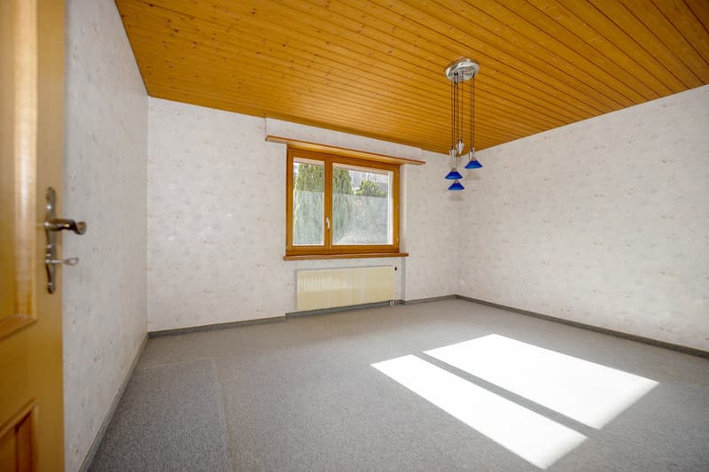 empty room, wooden ceiling, white walls, grey carpet, large window, ceiling lamp