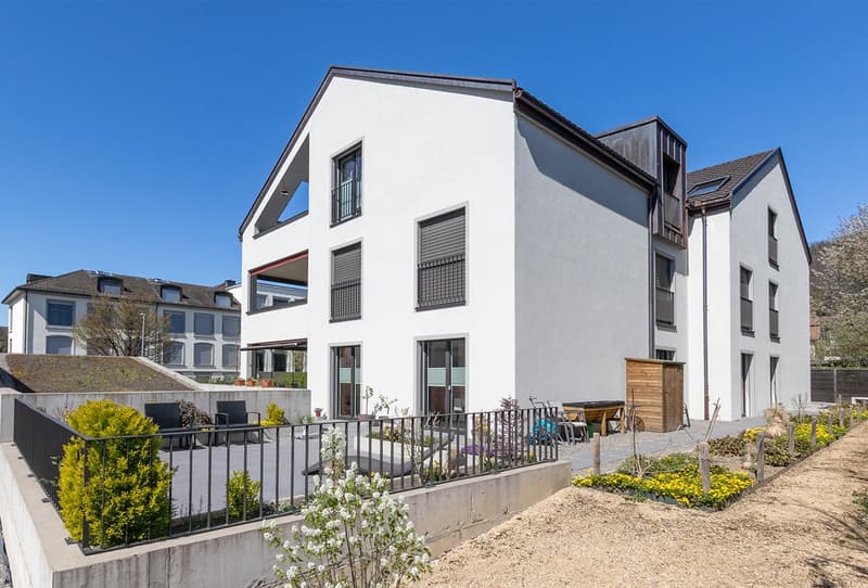 Modern white house, 3 floors, large windows, balcony, garden, patio with black railings
