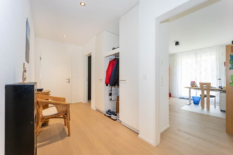 wooden floor, white walls, built-in wardrobe, wicker chair, desk, chair, window with curtains