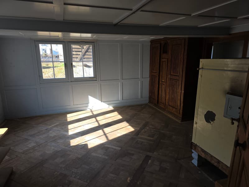 empty room, wooden floor, white walls, wooden cabinet, window, door